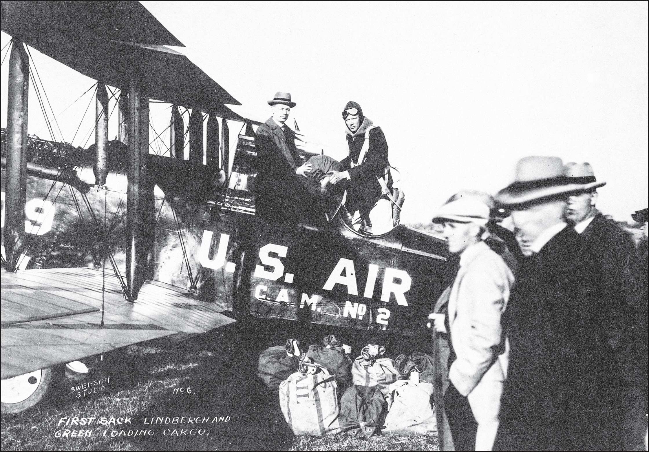 Charles loads mail into a Robertson mail plane around 1926 It was while flying - photo 11