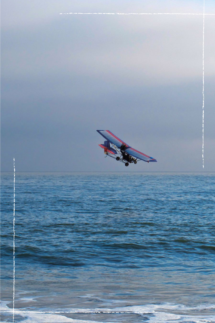 A motor powered glider cruises low over the ocean near Leo Carrillo Sunset - photo 1