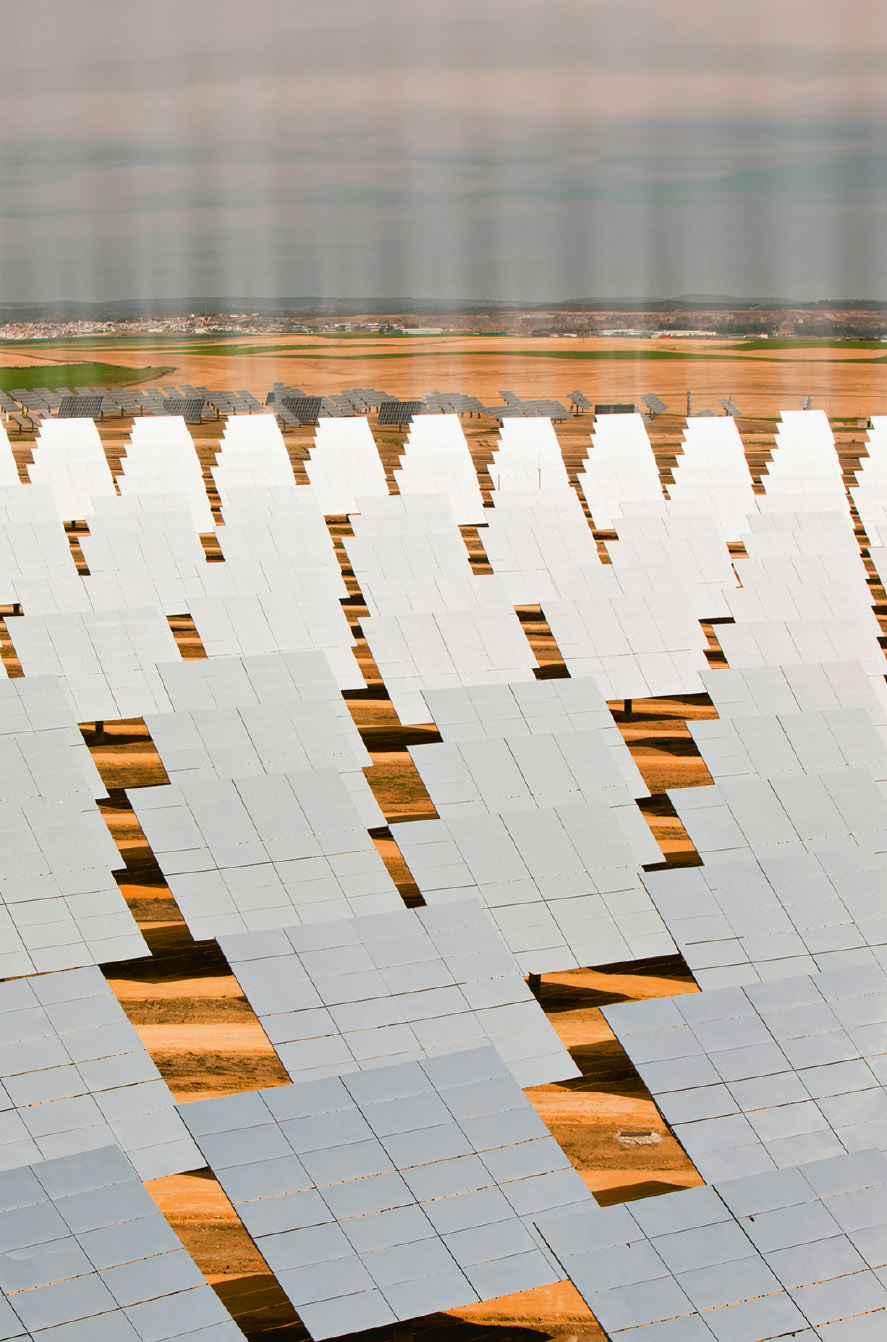 An array of reflective mirrors focuses sunlight onto a solar tower at the - photo 7