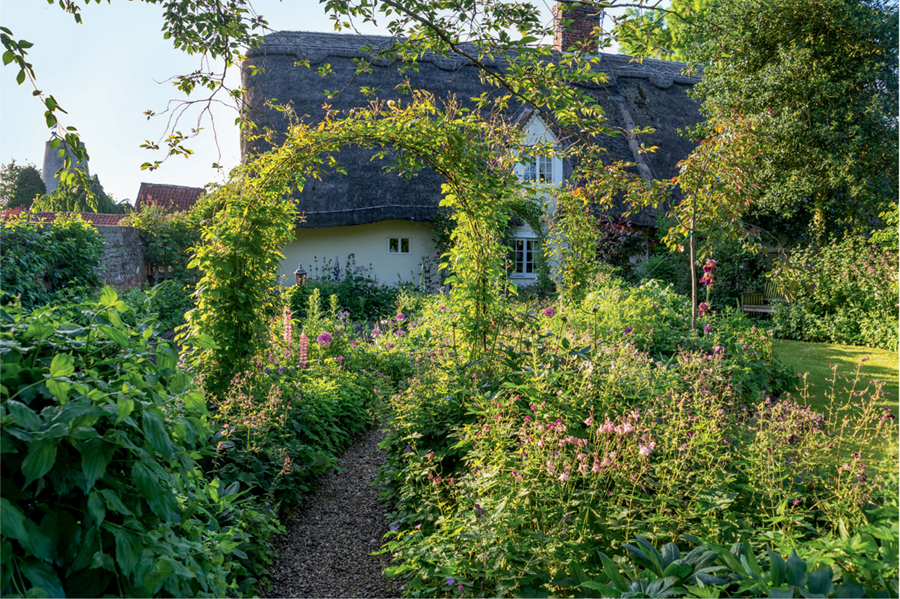 The classic cottage garden with its rose arch simple path and mingled - photo 6