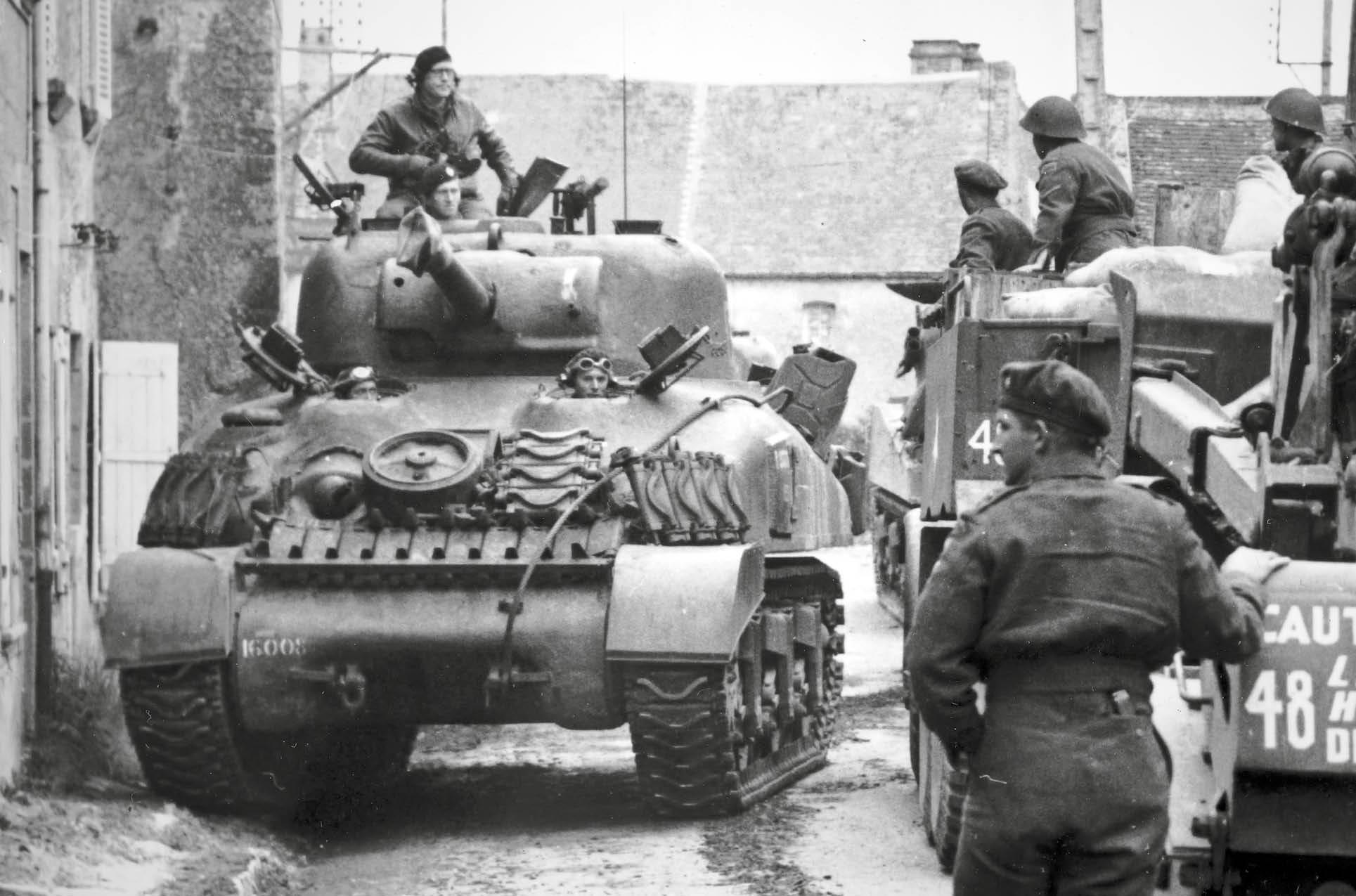 A Sherman II of the 4th Armoured Brigade moving forward from the landing - photo 4