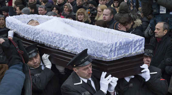 People stand around as workers carry the coffin of Boris Nemtsov during a - photo 2