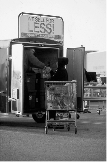 An Amish woman loads her grocery purchases into a cargo van driven by a - photo 4