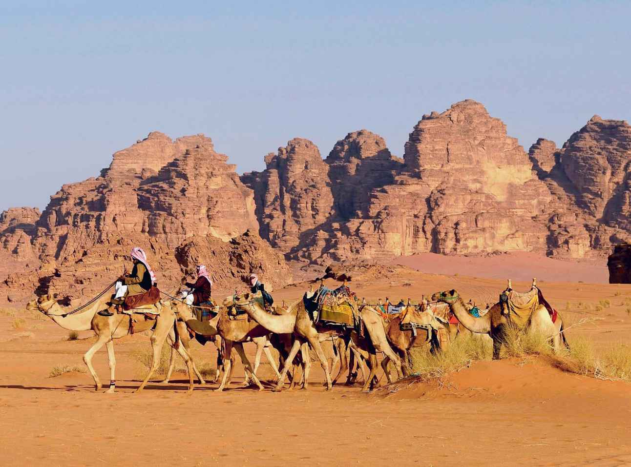 Bedouin tribesmen and their camel caravan travelling in Wadi Rum Jordan - photo 6