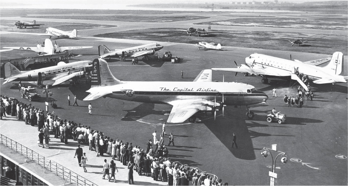 A busy scene of early piston airliners at New York La Guardia during the - photo 6