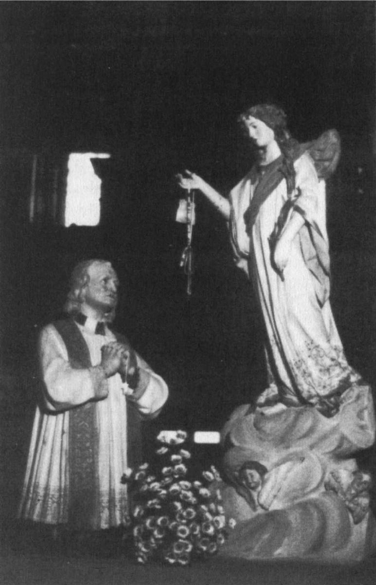 A statue of St John Vianney the Cur of Ars 1786-1859 kneeling before a - photo 2