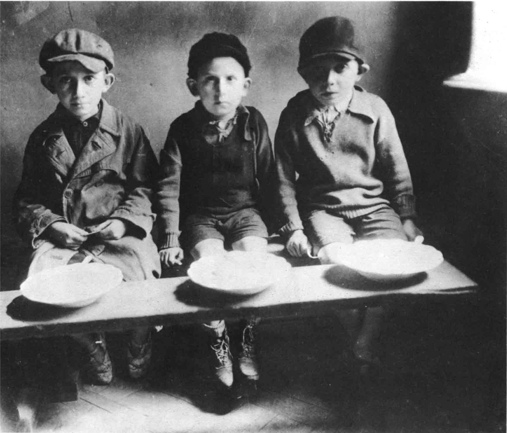 Three children in the Warsaw ghetto This photograph was taken in 1941 by a - photo 3