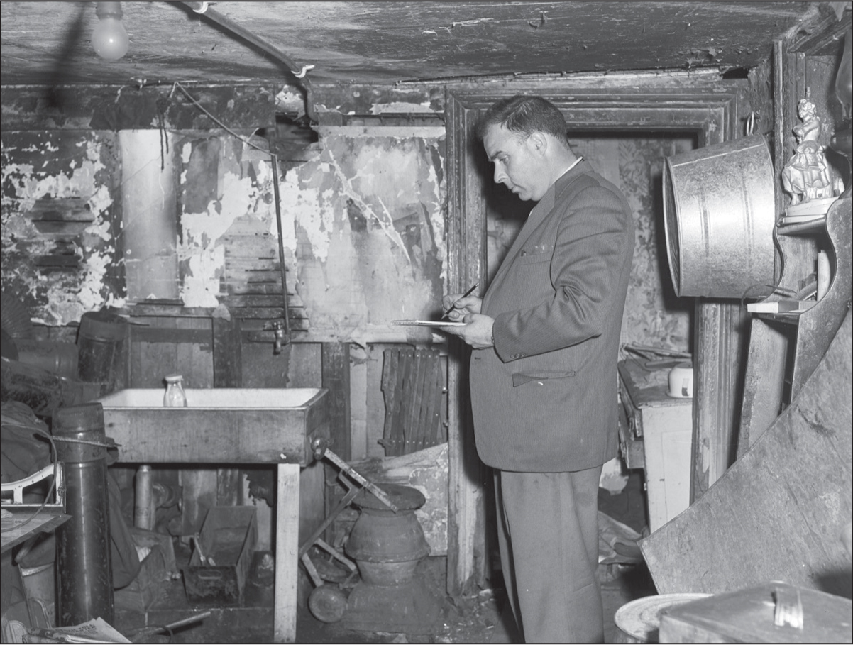 A Halifax City Engineering and Works inspector studies a condemned building on - photo 4