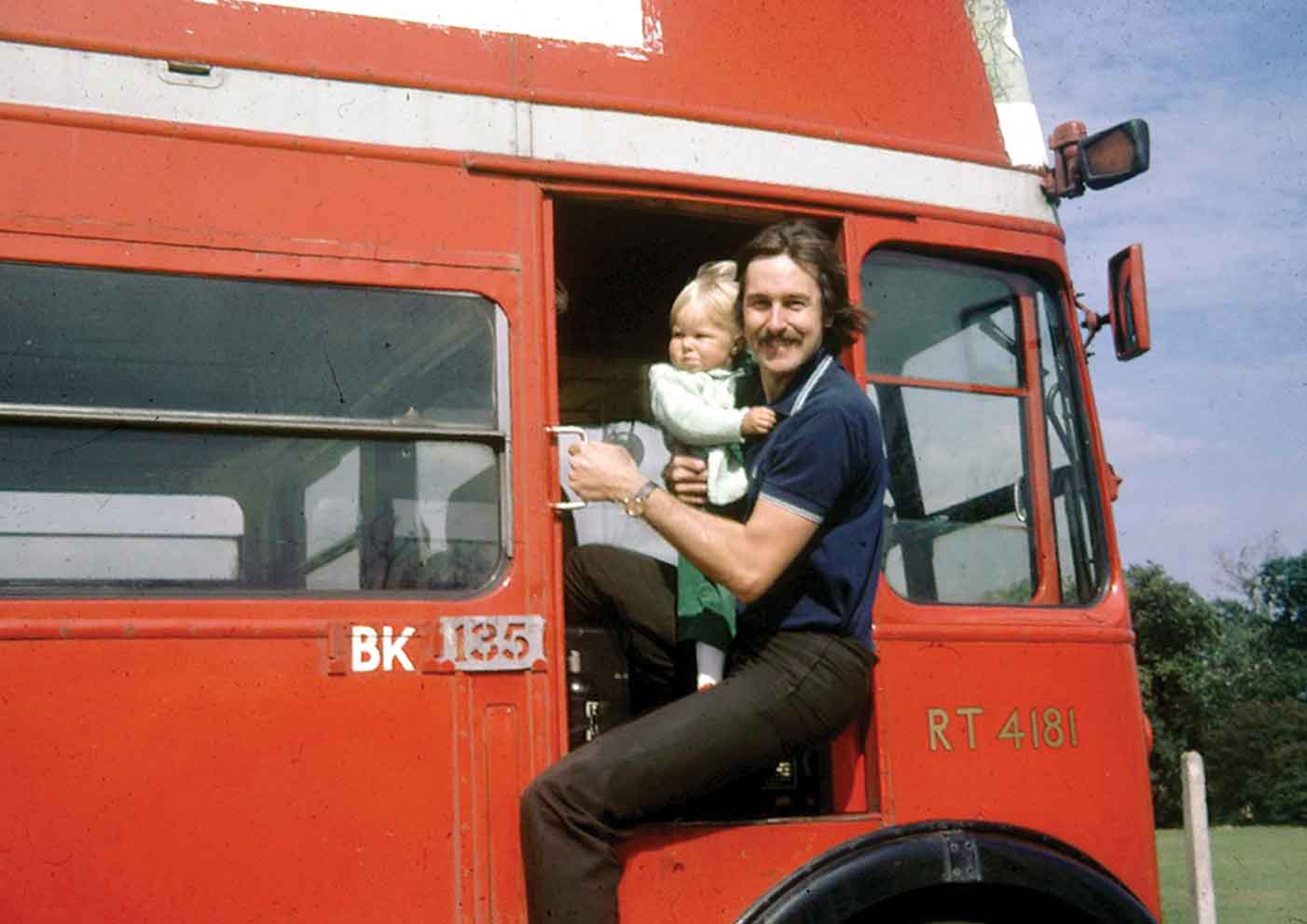 The author holding his 14-month-old daughter Laura poses precariously at the - photo 2