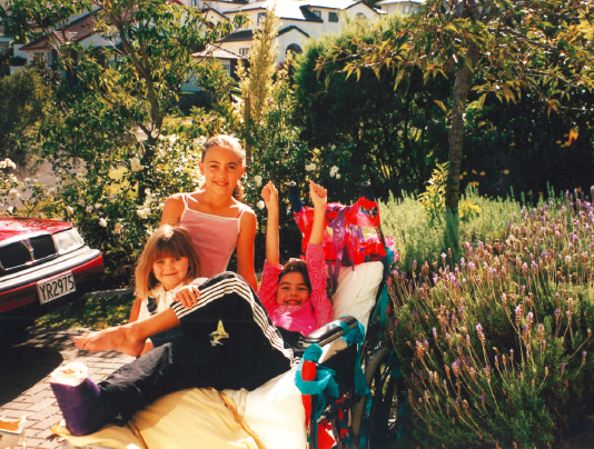 My sisters checking out my hip spica and wheelchair outside our house in - photo 6