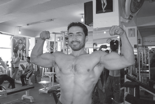 Figure 1 Man showing his muscles in a body-building club in Kabul Photo by - photo 5