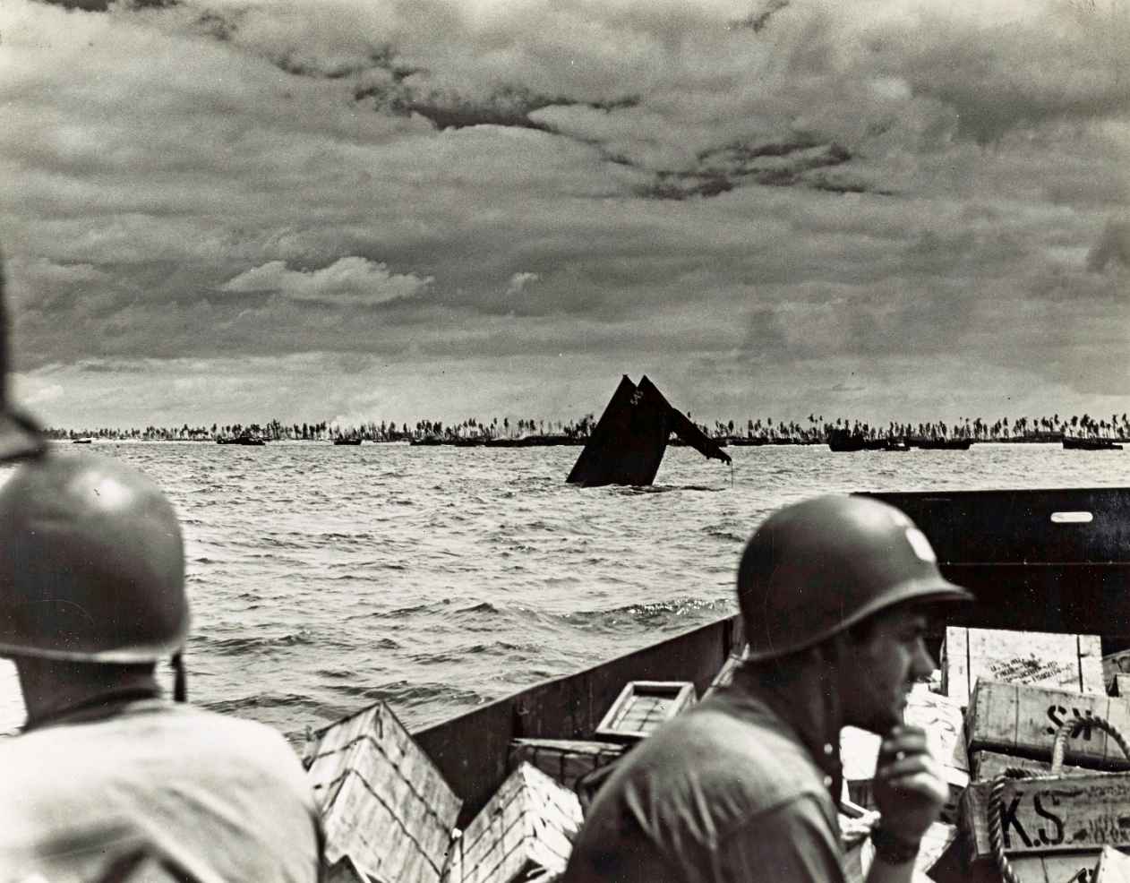 US Coast Guardsmen at Tarawa pass the protruding hulk of an American tank - photo 6