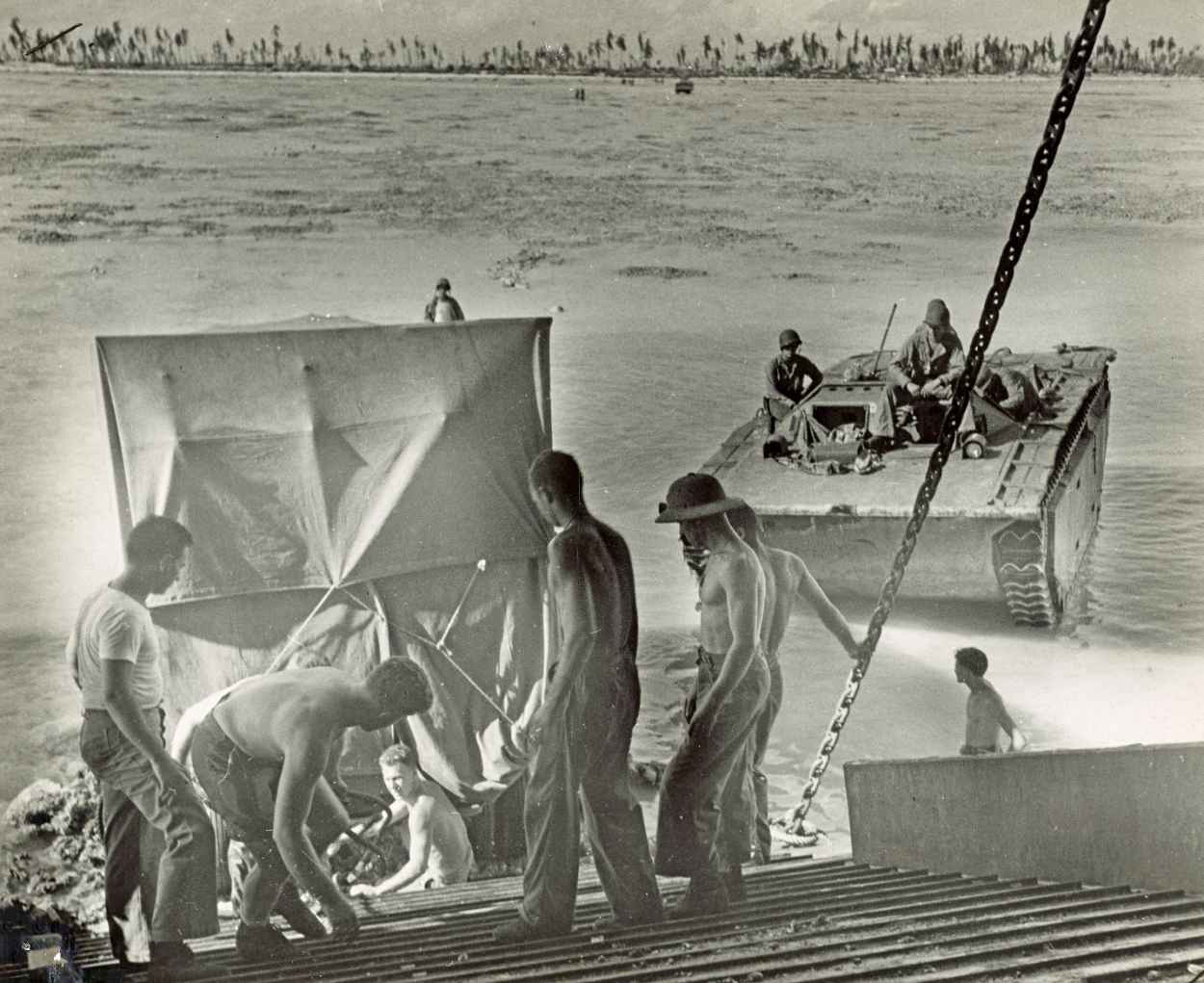 Crew members of a Coast Guard manned LST unload heavy equipment at Bititu - photo 11