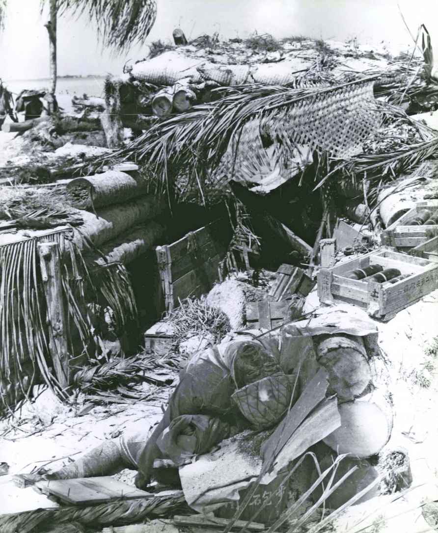 A dead Japanese soldier lies near the gun shelter of a 77mm gun they used to - photo 13