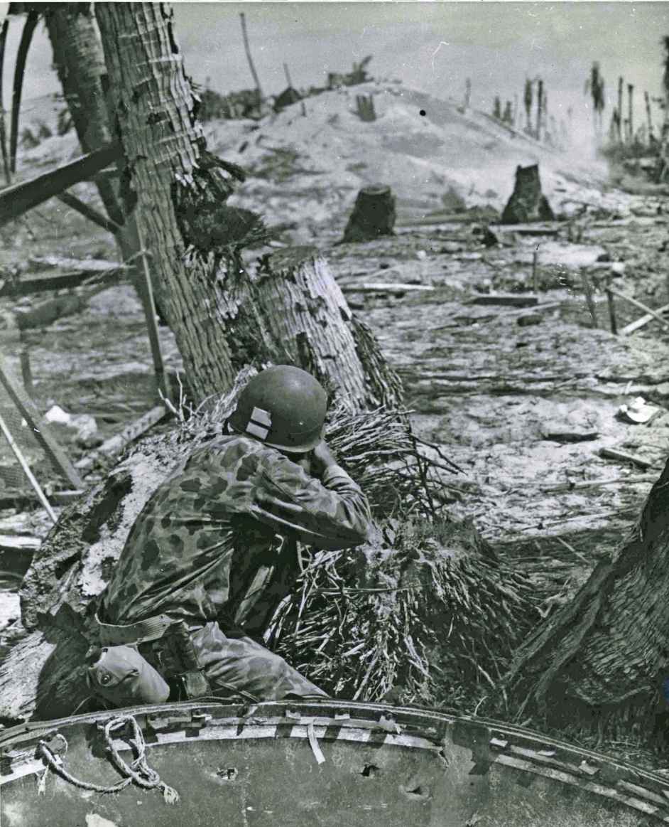 Taking the slim protection that a blasted tree affords this Marine picks off - photo 14