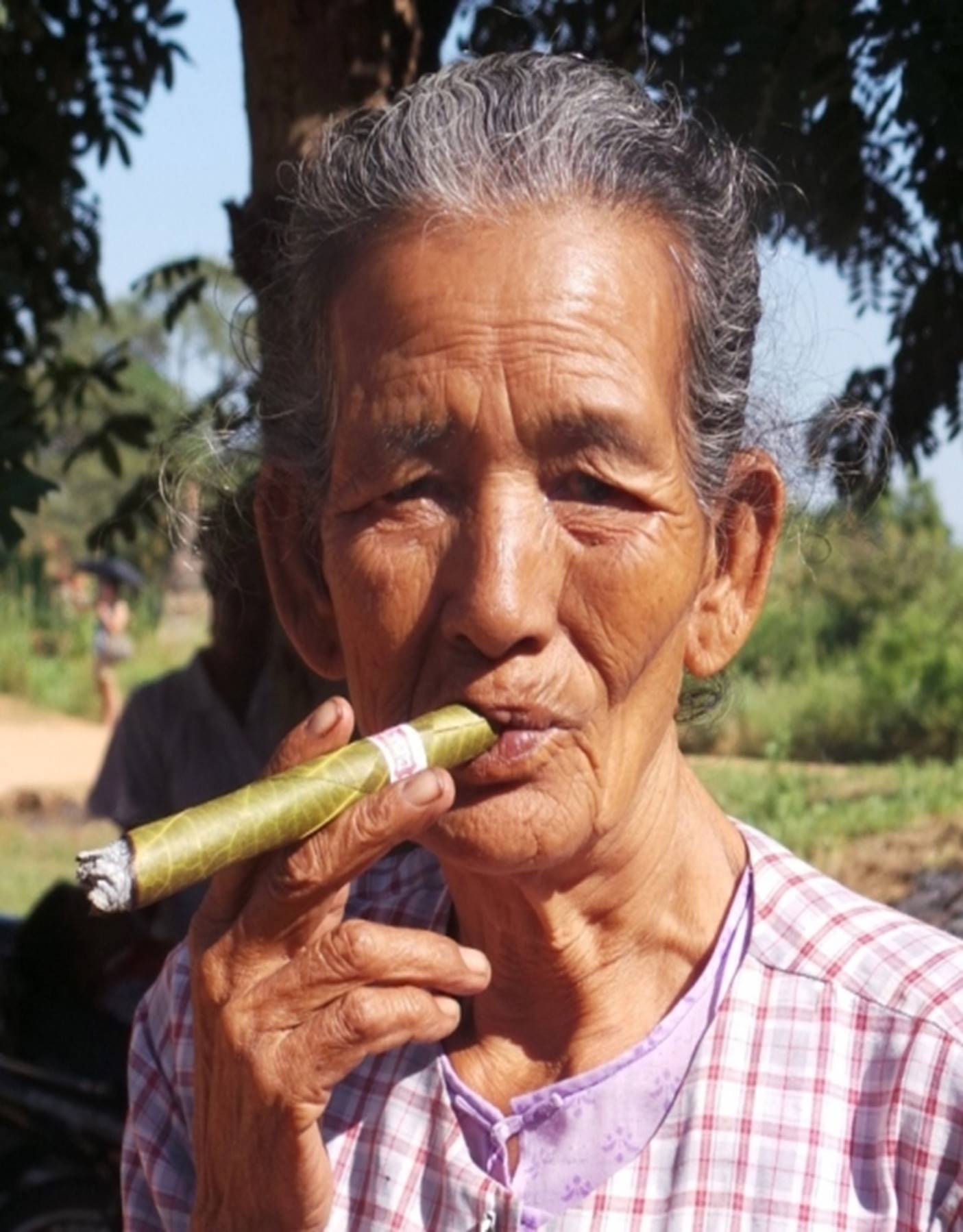 Enjoying a Cheroot or Burmese cigar the new Burma Myanmar which was - photo 3