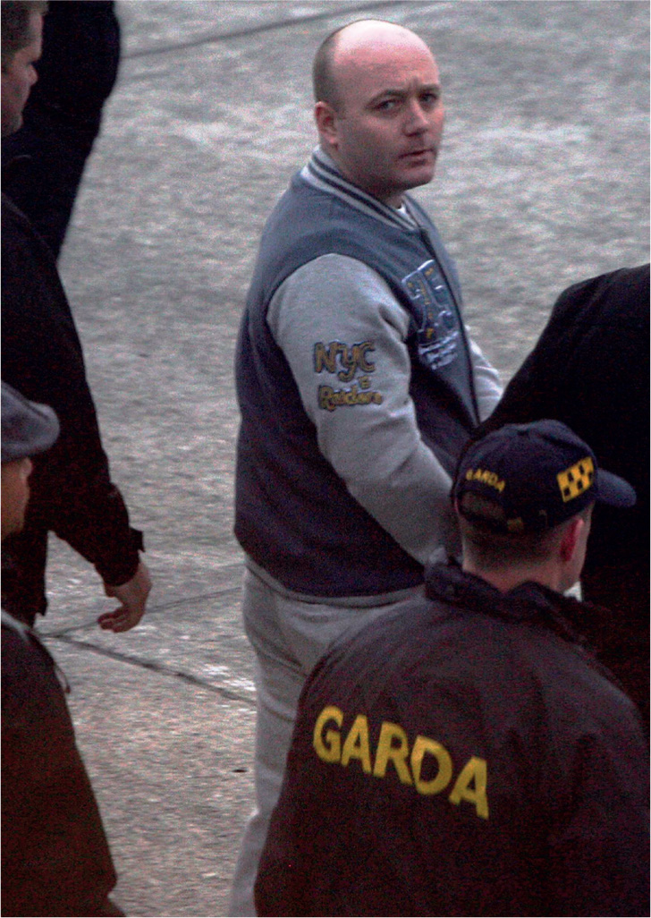 19 Garda escort Thompson to a plane ahead of his extradition to Spain under - photo 20