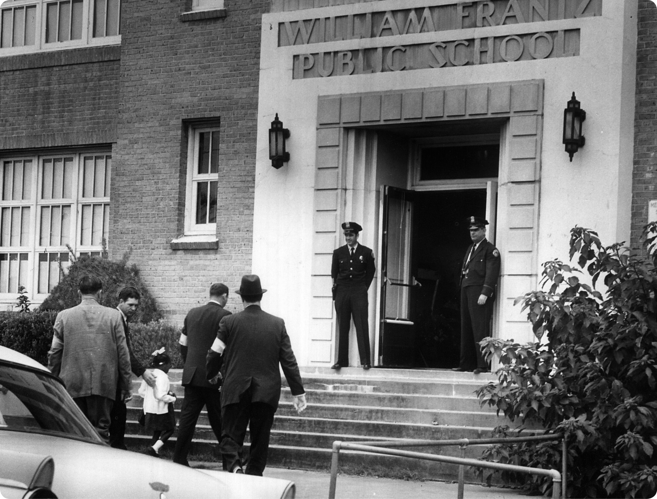 Police officers flank the entrance for Rubys arrival on her first day 1960 - photo 8