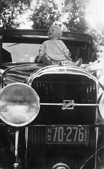 At age one on our neighbors Buick I tell people that I was born in the Happy - photo 3