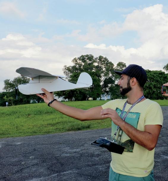 A man gets ready to fly his homemade drone in a park in Singapore To build a - photo 7