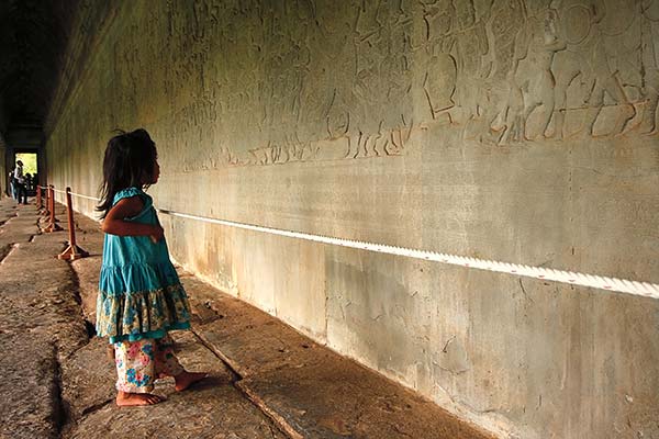 Khmer girl looking at bas-reliefs inside Angkor Wat And you can add to the - photo 13