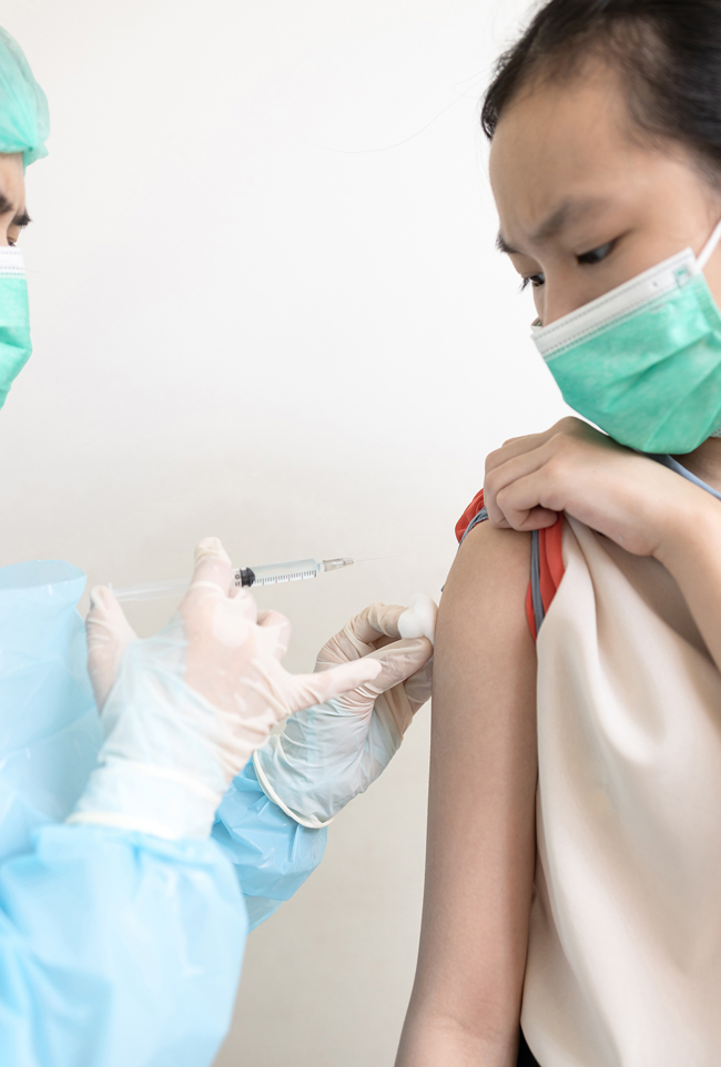 A doctor administers the COVID-19 vaccine to a woman to produce immunity - photo 1