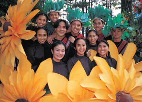 Yellow daisy flower teenagers about to join the street parade at the - photo 1