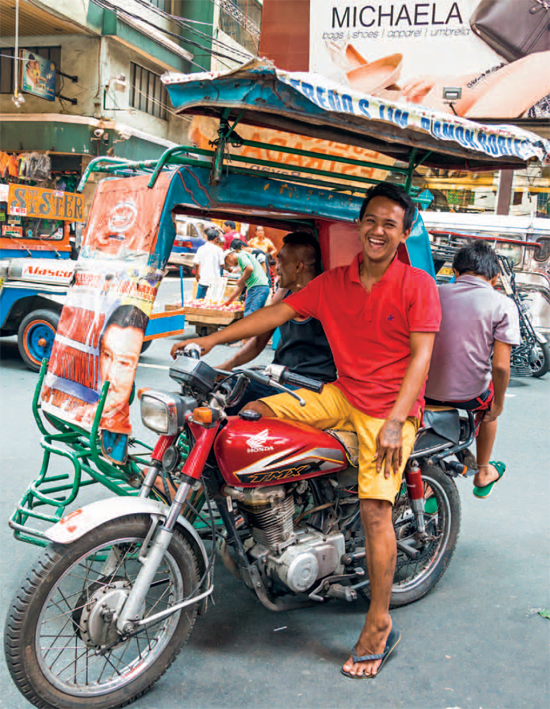 A tricycle driver enjoys a laugh in Divisoria Market Manilas largest street - photo 4