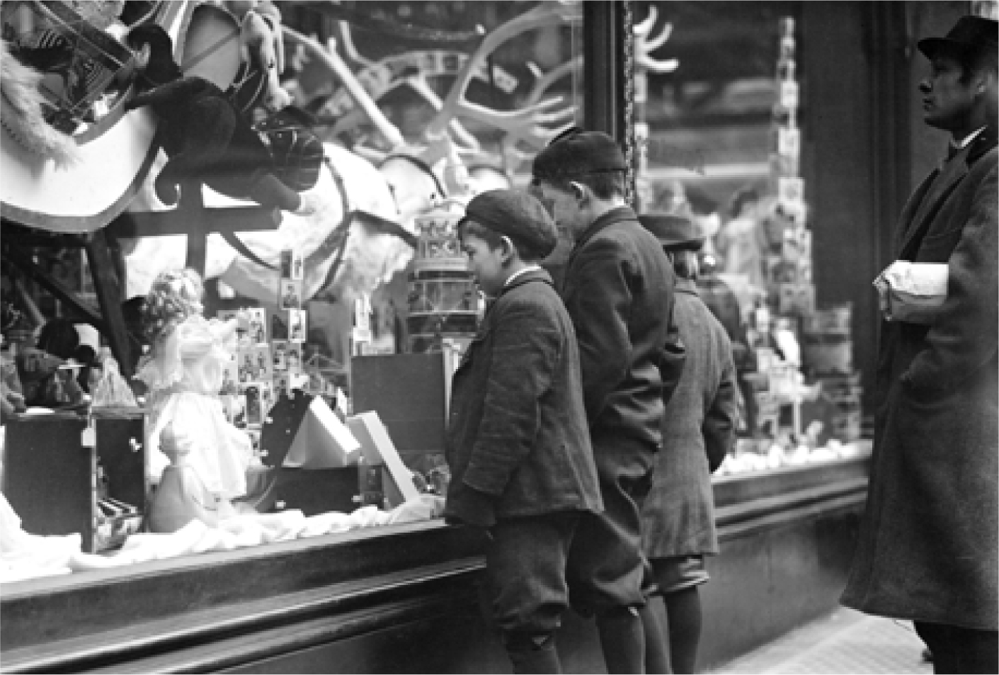 Children look through a store window at toys on display during the Christmas - photo 3