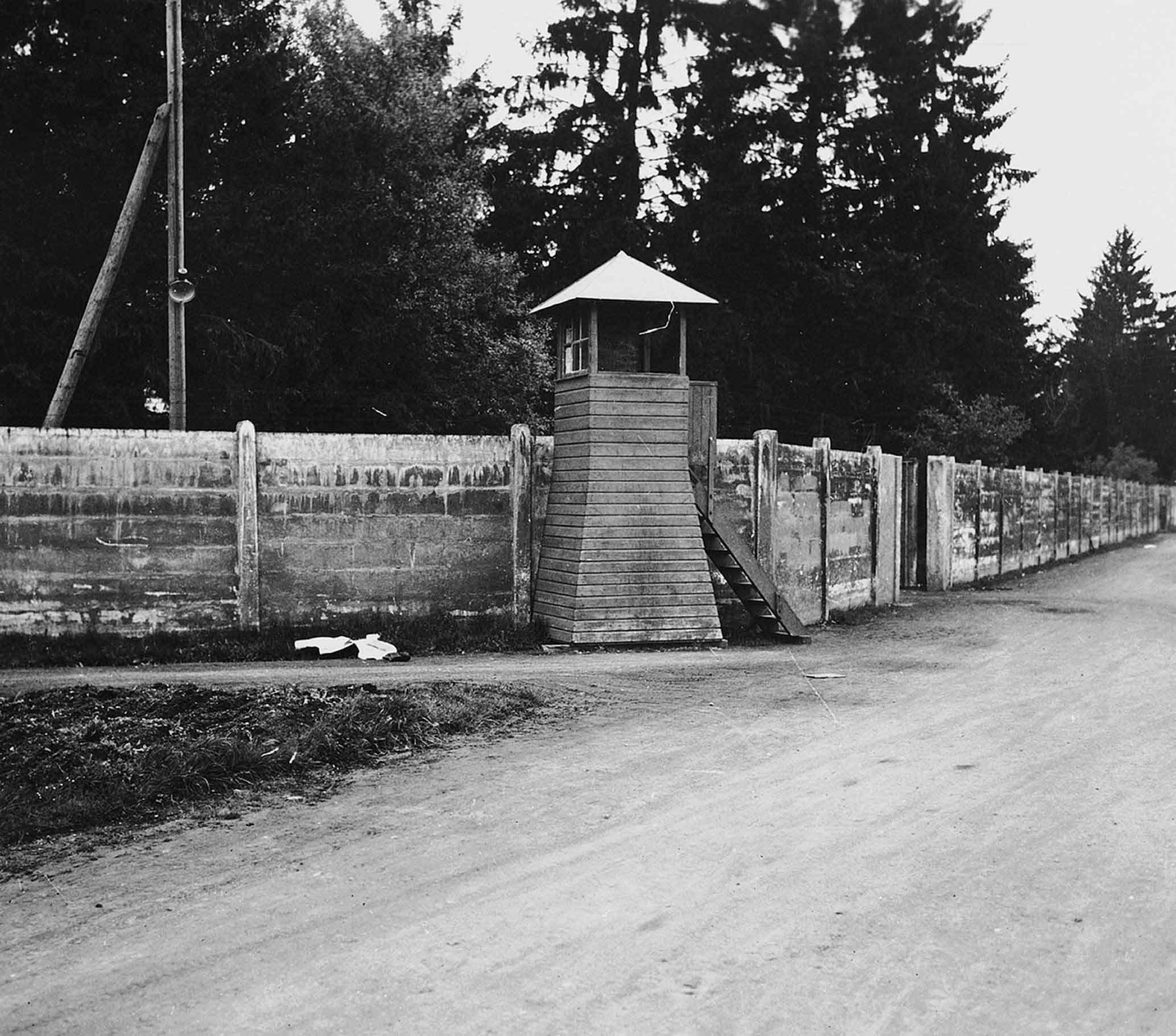 View of a wall and guard tower at Dachau Life for the prisoners inside Dachau - photo 5