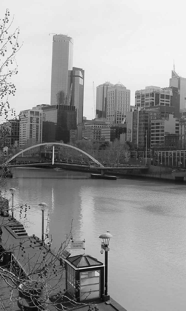 Pedestrian bridge over the Yarra River with view of the cityscape in the - photo 5