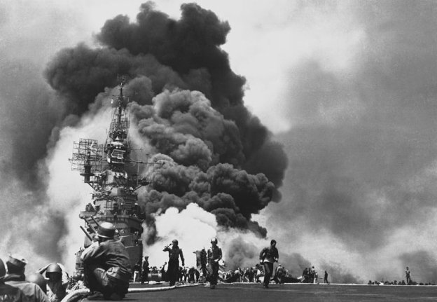 Picture of the USS Bunker Hill being hit by a kamikaze during the Battle of - photo 1