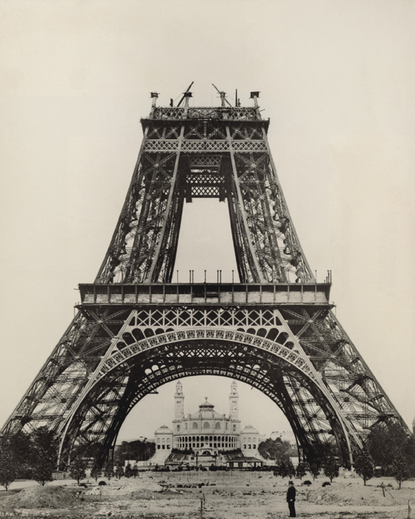 Engineer Gustave Eiffel stands below the Eiffel Tower during its construction - photo 3