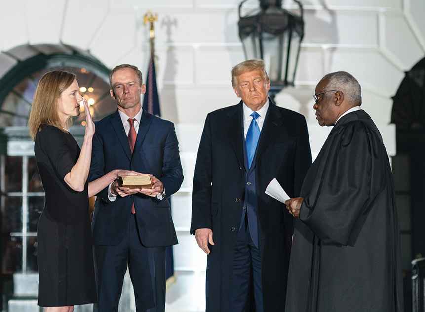 Justice Clarence Thomas administers the Constitutional oath to Amy Coney - photo 17