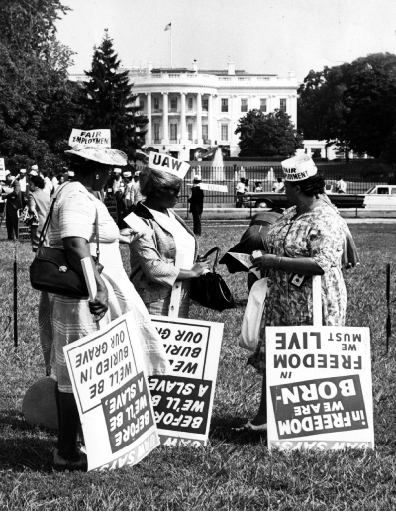 African American women holding signs and wearing hats that show United - photo 2