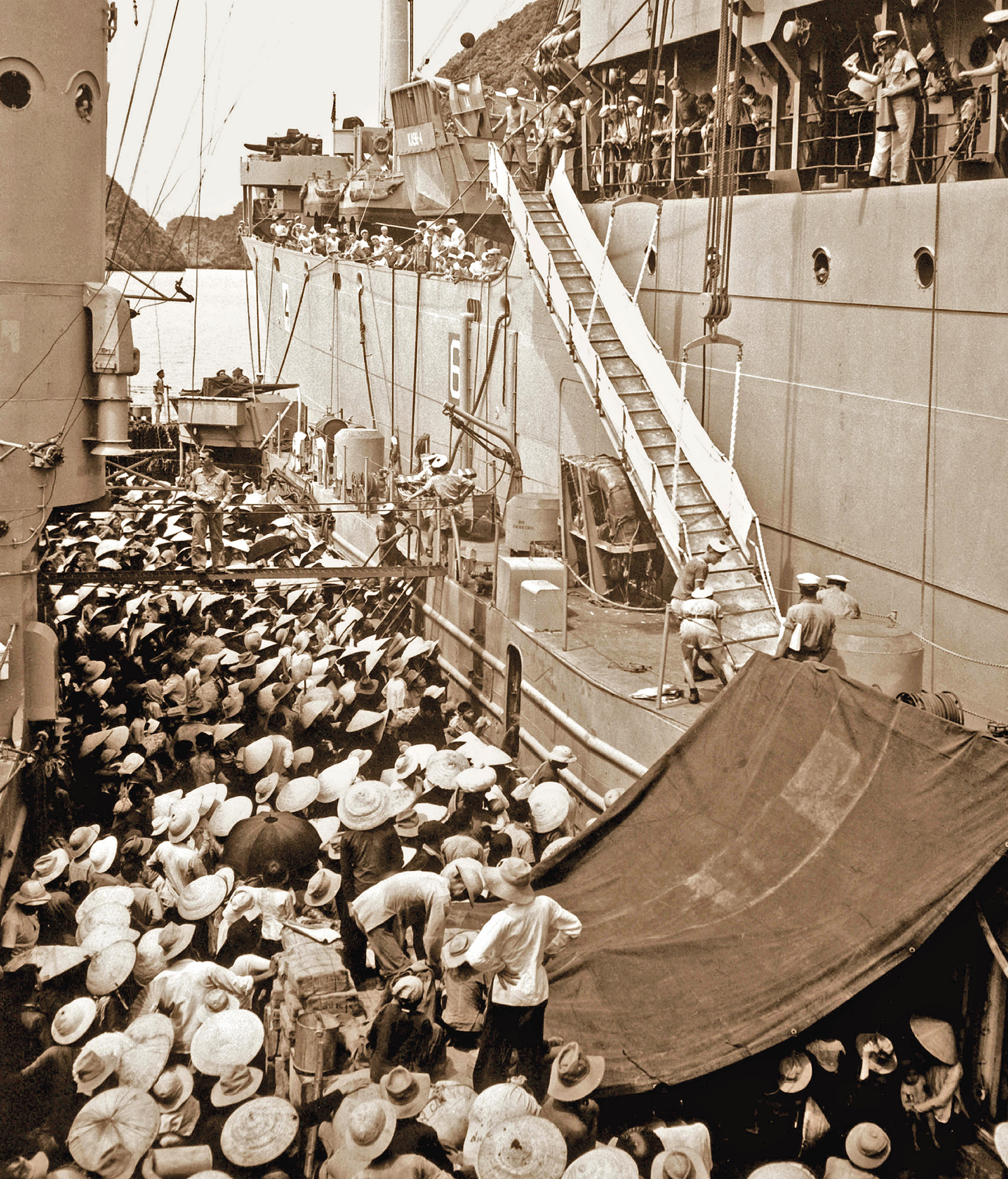 Vietnamese refugees board the USS Montague from a French landing ship at - photo 5