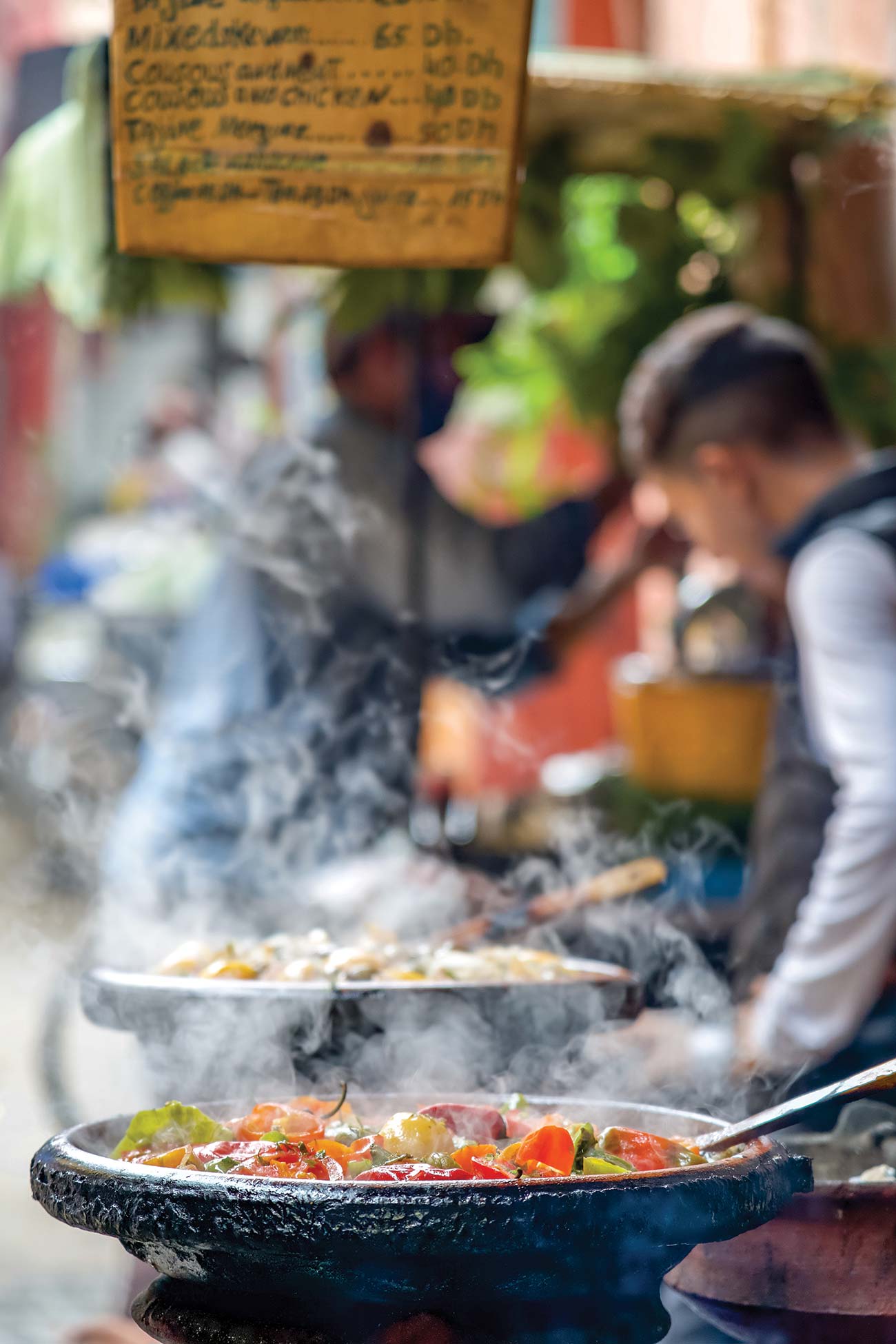 A tajine cooks in the busy medina seeking isolation in traditional - photo 6