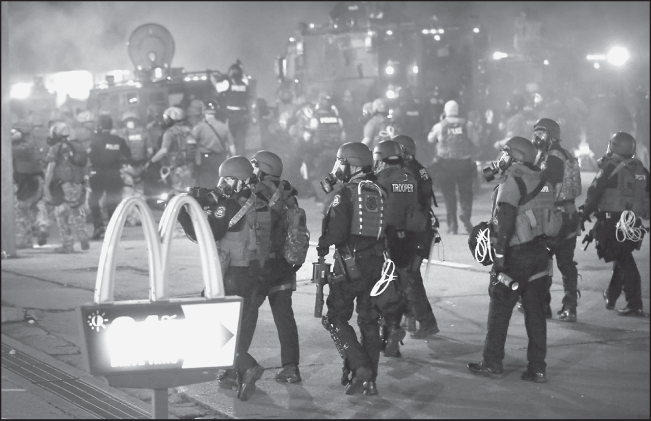 Police and National Guard forces swarmed the McDonalds on Florissant Avenue in - photo 3