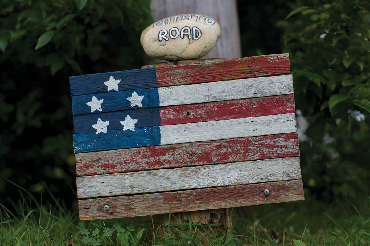 This handmade wooden flag artist unknown on the side of a beach road serves - photo 6