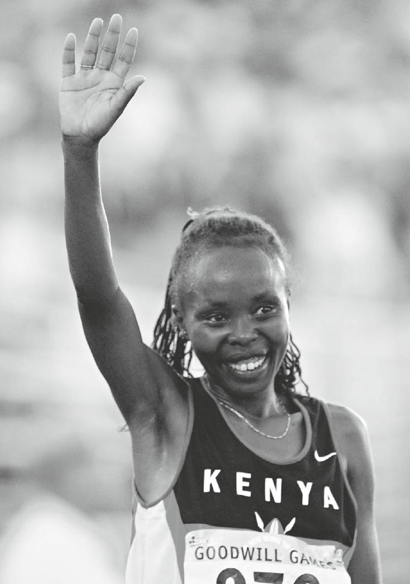 Tegla Loroupe waves to the crowd after winning the womens 10000 metre race at - photo 4