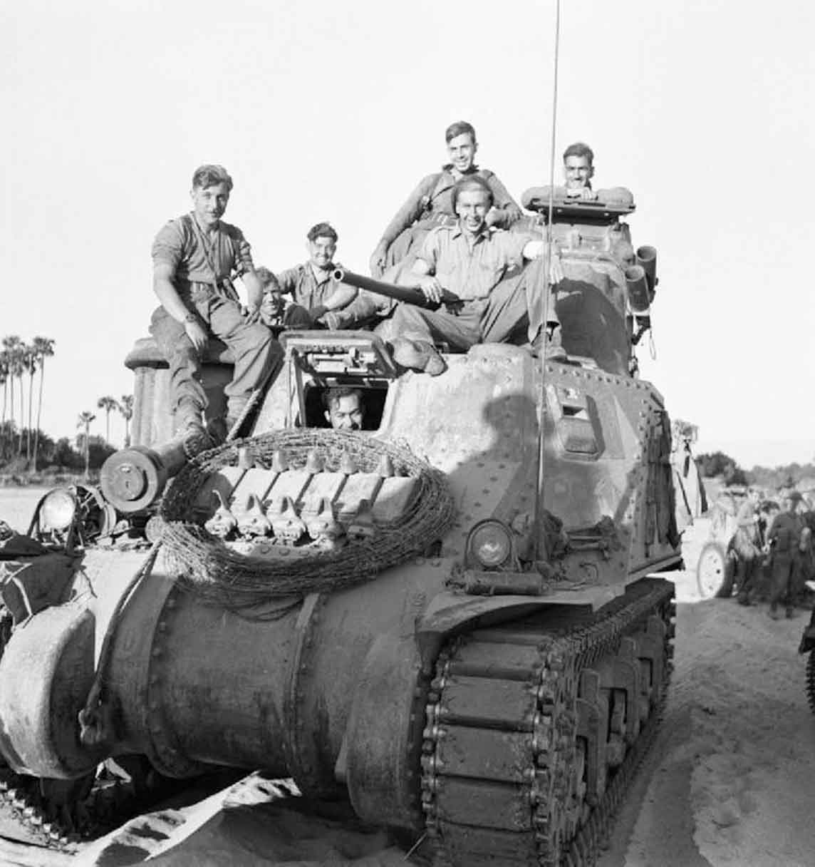 A British M3 Lee medium tank and its happy looking crew on the banks of the Mu - photo 1