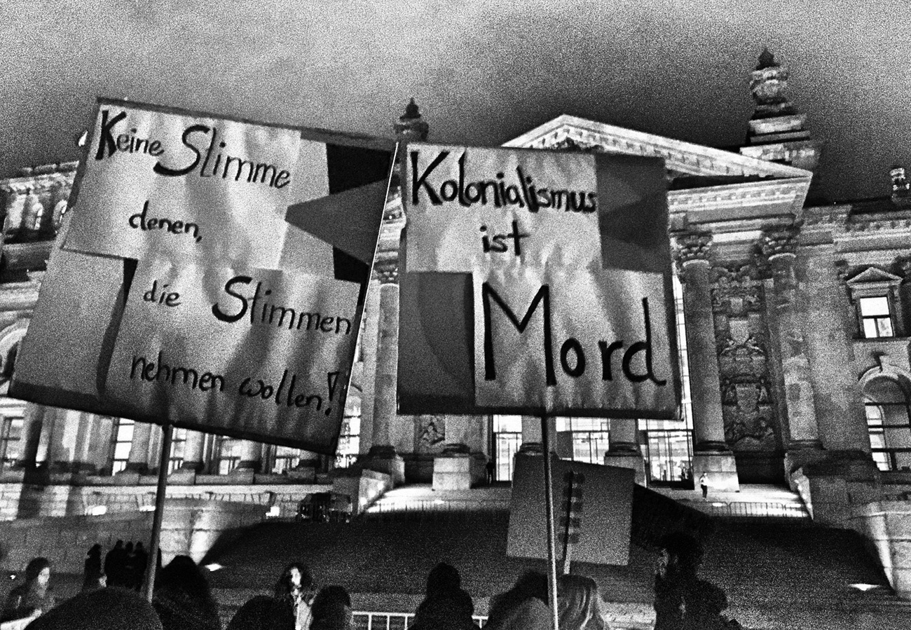 Activists protest the authors talk on colonialism inside the Reichstag Building - photo 3