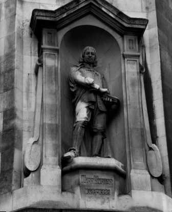 A statue of John Bunyan holding a copy of The Pilgrims Progress stands in a - photo 7