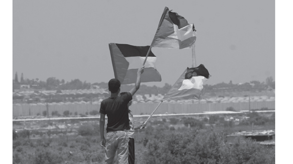 Palestinian boys wave a Palestinian flag during a demonstration to mark the - photo 5