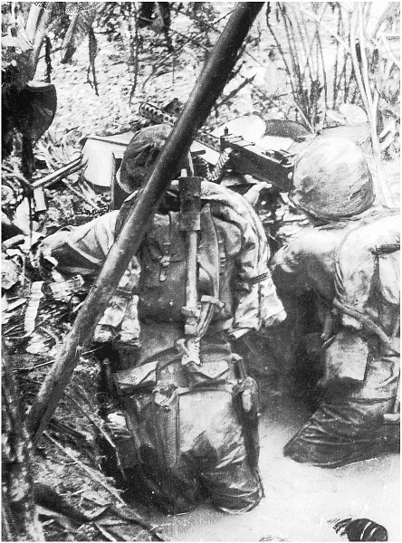 Raiders up to their hips in water man a machine gun along a jungle trail - photo 4