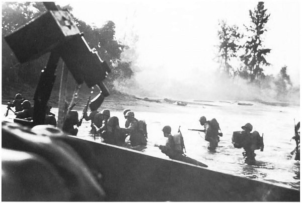 As seen from a beached landing craft these Marines are under fire while wading - photo 7