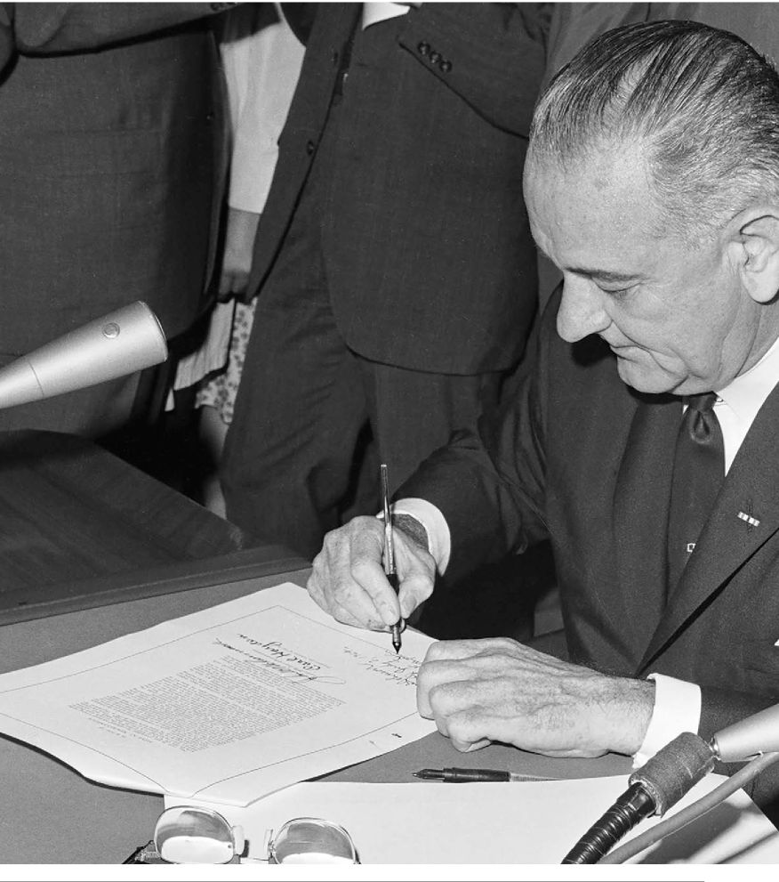 President Lyndon B Johnson signs the Civil Rights Act of 1964 to create a - photo 7