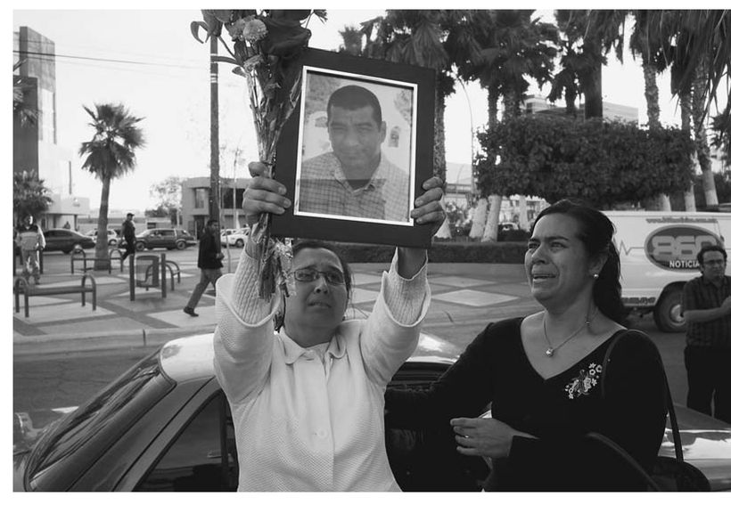 BLANCA MARTNEZ RAISES THE PHOTOGRAPH OF HER HUSBAND ARMANDO RODRGUEZ WHILE - photo 3