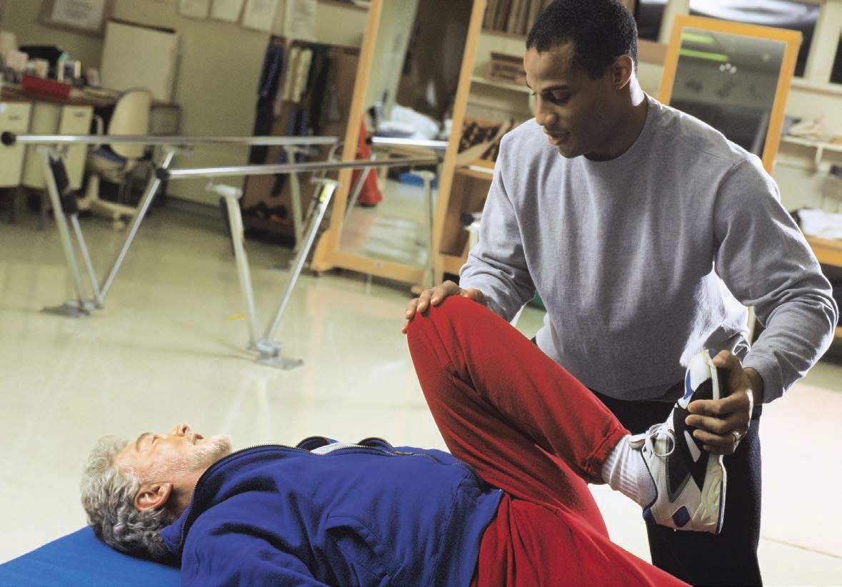 Physical therapy assistants help patients exercise limbs after injury or - photo 4