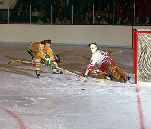 Bob Liddington of the Chicago Cougars and I both watch the puck head to the - photo 17